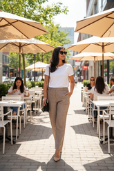 Model wearing brown linen pants at street café