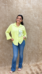 Lime green handwork shirt worn loose with flared jeans and nude heels