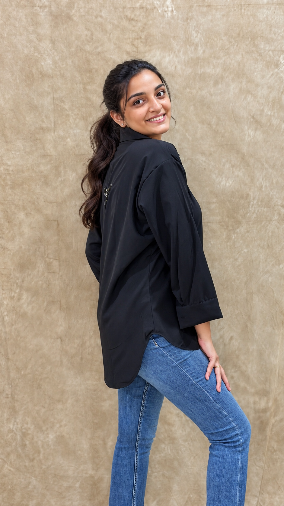 Back view of black shirt showing the hand-embellished dragonfly on the upper back