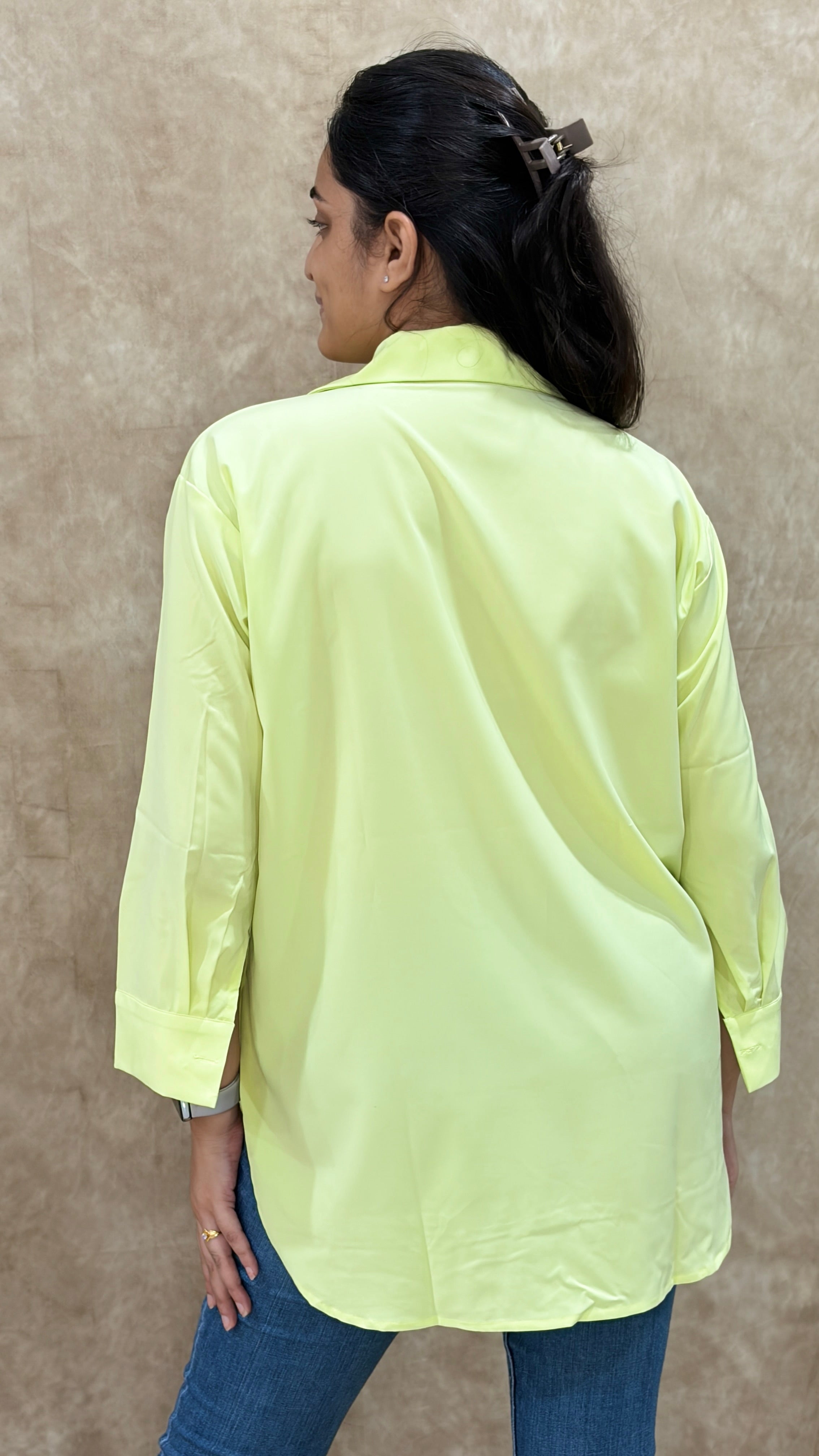 Back view of lime green relaxed-fit shirt with buttoned cuffs