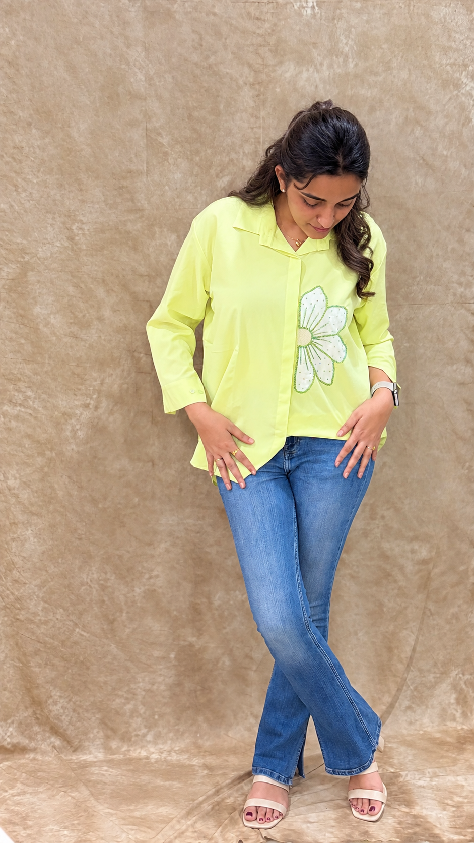 Lime green handwork shirt with a curved high-low hem, worn with blue denim