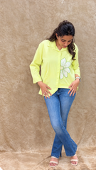 Lime green handwork shirt with a curved high-low hem, worn with blue denim