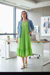 Model in green dress with shrug at office