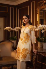 Model in golden kurta set indoors minimal jewelry