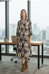 Bohemian Noir Palm Print Cotton Midi Dress - model wearing black and beige printed dress in office setting