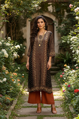 Model with rust pants and gold accessories